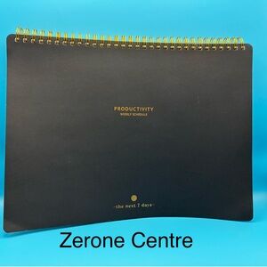 Zerone Productivity weekly planner featuring a gold spiral binding.